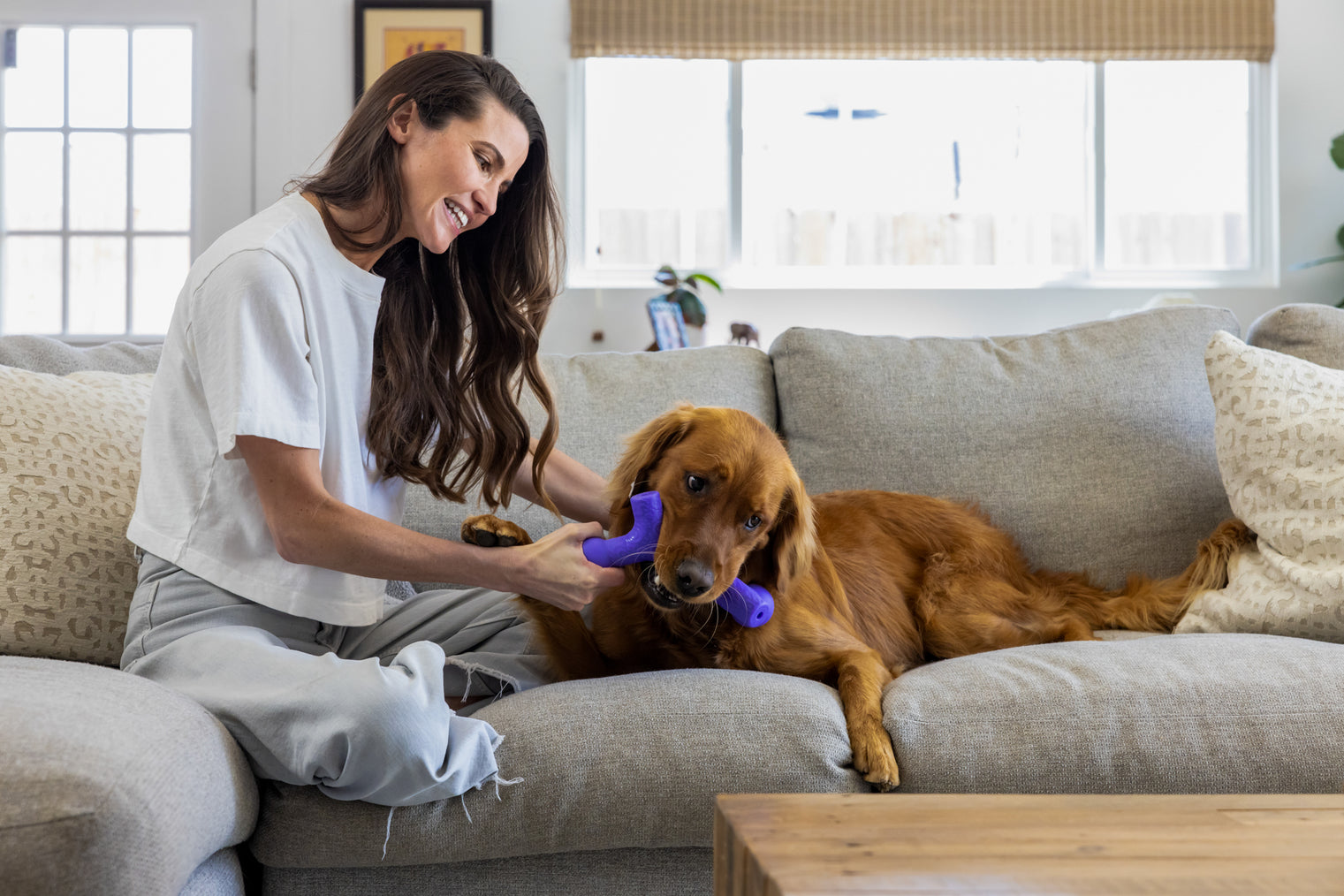 Woman playing with her dog using Yomp chew toy